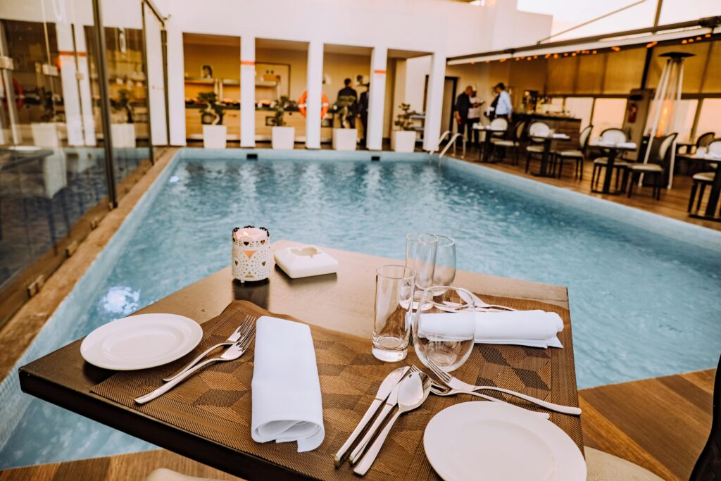 Relax by the poolside with this elegant dining setup at a luxurious resort.
